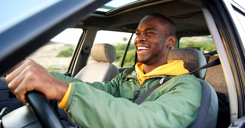 happy african american man driving car