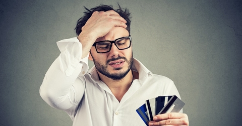 stressed man having debts with credit card