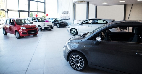 car dealership showroom interior with brand new vehicles for sale