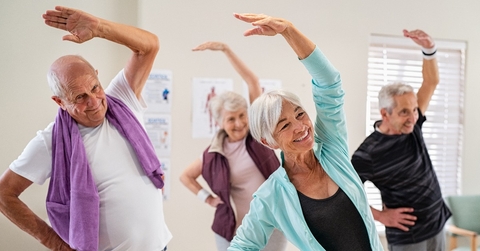 Senior people stretching at gym