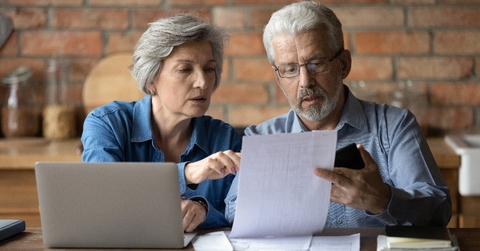 serious mature couple checking financial documents