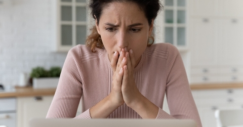 Shocked hispanic female read unexpected bad news on pc