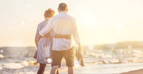 elderly couple hugging on seacoast