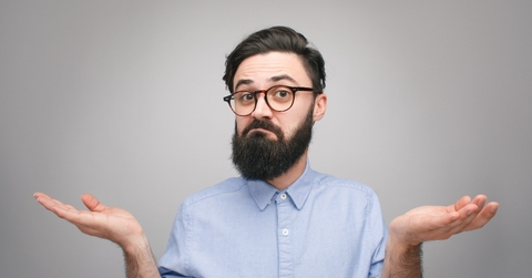 Confused man holding hands apart