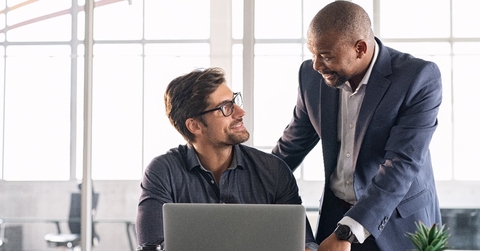 mature executive helping new employee
