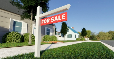real estate sign in front of a house for sale 