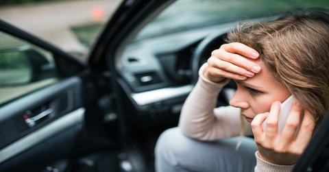 Woman worried in the car making a phone call