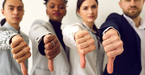 disappointed young multiethnic people give thumbs down