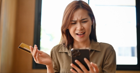 asian woman unsatisfied with an online shopping application 