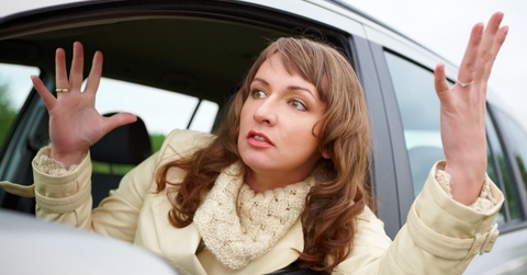 angry young woman sitting in a car