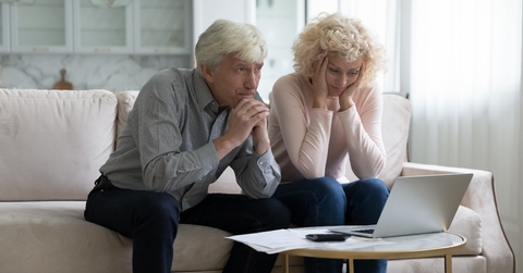 mature husband and wife frustrated about overspending family budget 