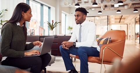 businesswoman interviewing male job candidate