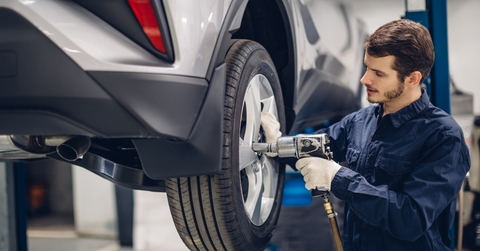 Car mechanic changing a tire