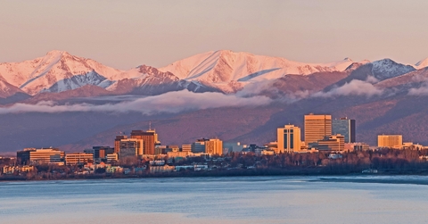 sun setting over anchorage skyline