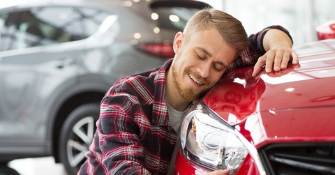 man buying a new car at the dealership