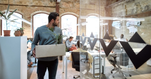 employee holding a box of personal belongings after leaving
