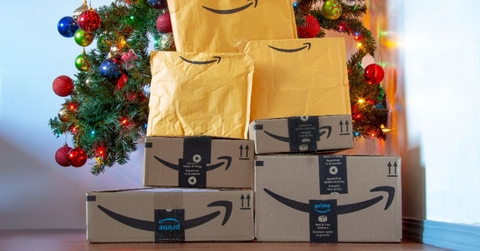 Amazon packages in front of the Christmas tree