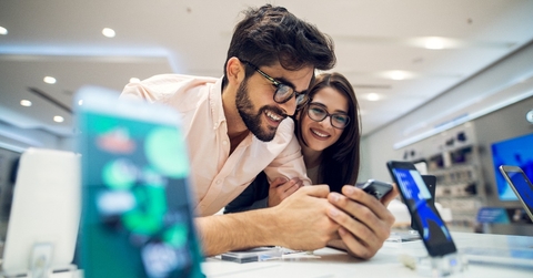  couple choosing a new mobile phone in a tech store