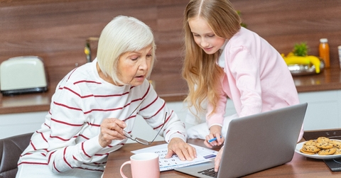 female grandchild and her granddaughter looking at the calendar