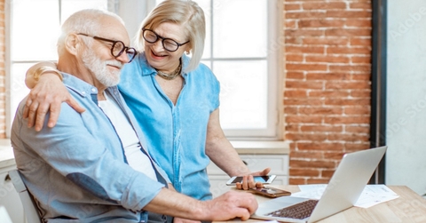 happy senior couple using laptop