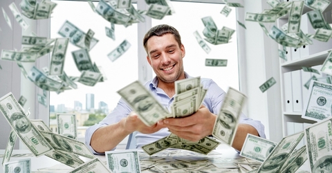 happy businessman with heap of money