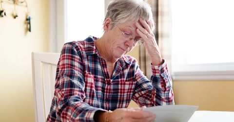 stressing senior lady reading document