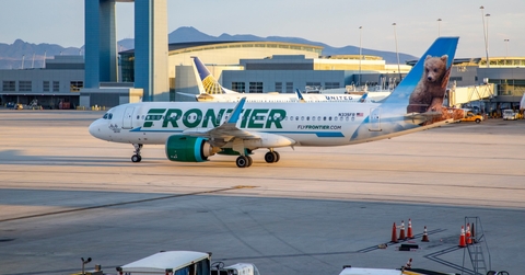 frontier airplane standing at las vegas airport during day time