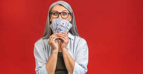 senior woman holding money