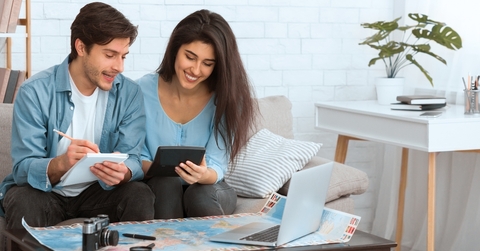 couple preparing for vacation and calculating expenses