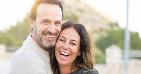 mature couple smiling while hugging each other 