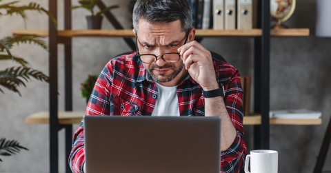 businessman in eyewear looking at computer screen