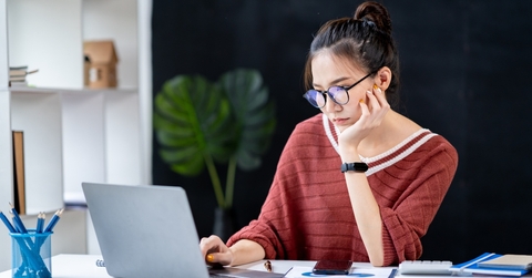 businesswoman looking at a notebook analyzing data