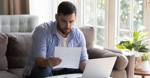 businessman doing paperwork at home