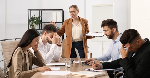 boss screaming at employees in office