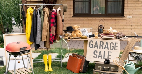 clothes and old suitcases at garage sale 