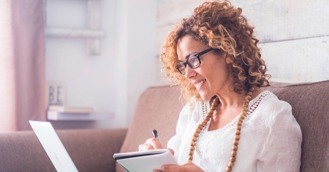 A middle-aged woman looking at computer