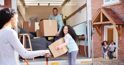 family unloading furniture from removal truck