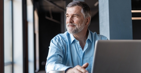 mature businessman working on laptop
