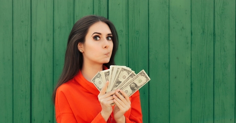 woman in red formal shirt holding money in hand 