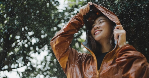 woman is outdoors while it&#x27;s raining