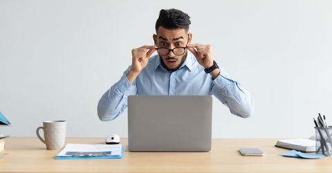 confused guy using laptop looking at screen