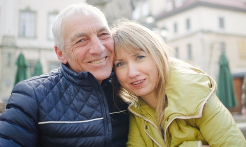 Smiling retired couple wearing winter jackets