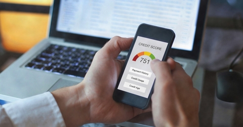 man holding smartphone showing credit score