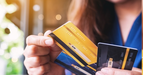 woman choosing credit card to make payment