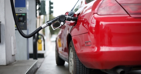 car at gas station being filled with fuel