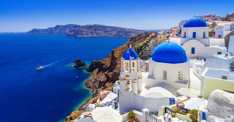white buildings with blue domes in oia town santorini island