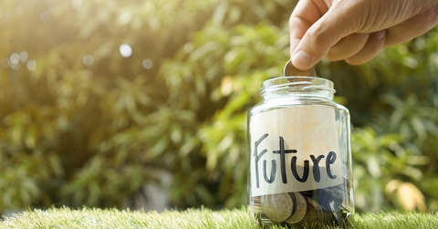 Person putting money in a jar labeled "future"