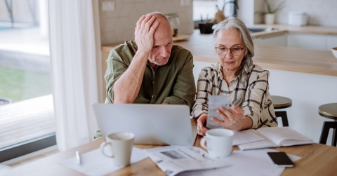 senior couple stressed while calculating bills to finalise budget at home
