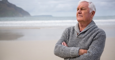 thoughtful senior man standing 