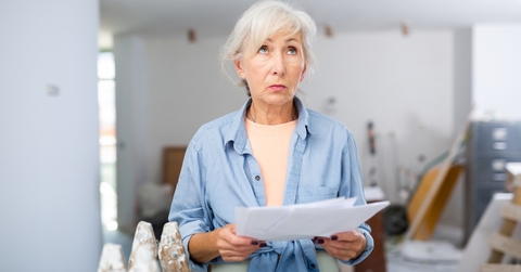 disappointed senior female designer examining room